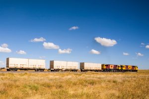 A shipping container train travelling through the outback.